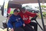 two women ready to roll in their golf cart