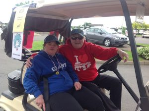 two women hanging out in a golf cart