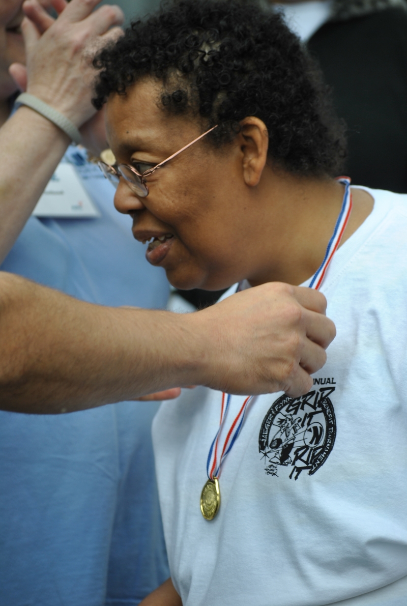 woman receiving her gold medal