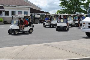 swarm of groups in golf carts preparing to start