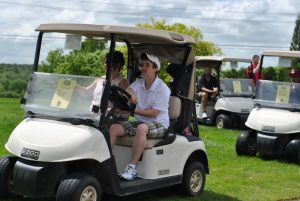 young man driving golf cart