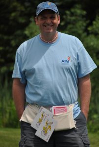 aim services team member wielding large playing cards on waist