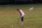 woman in hat shooting for the wickets