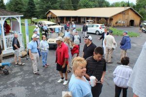people standing and talking before golfing event