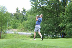 man holding his follow through after teeing off