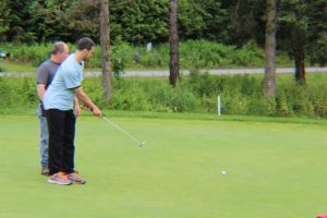 two golfers working the putting greens