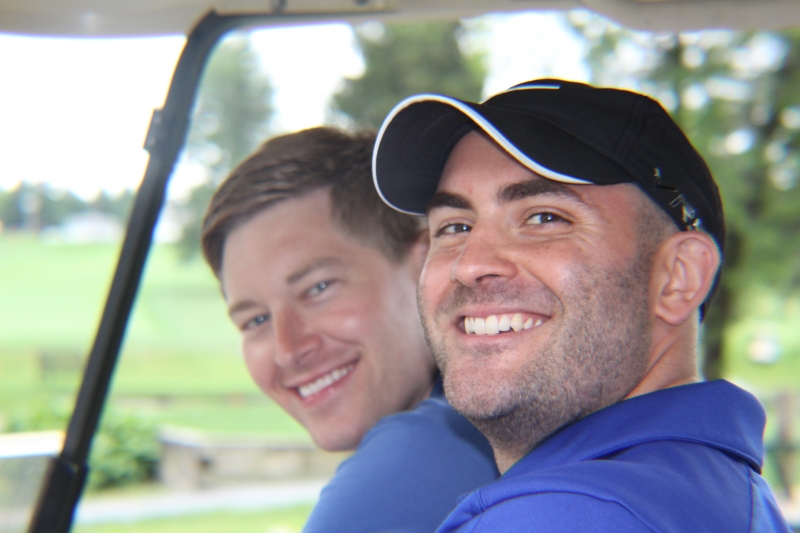 close up of two golfers smiling