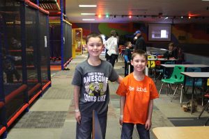 two boys smiling at indoor playground
