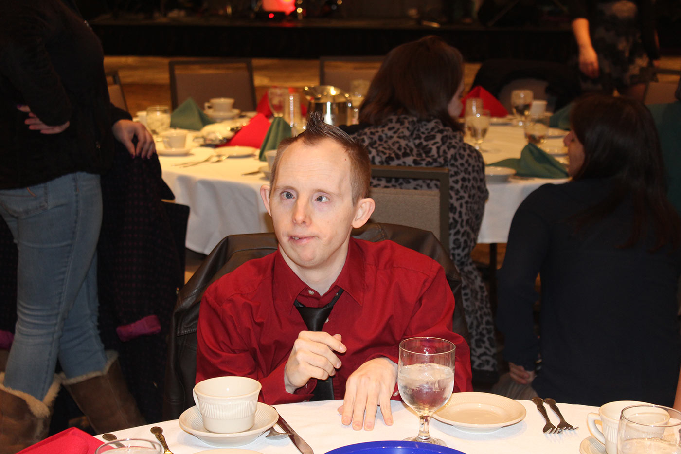 Man in red shirt seated at table