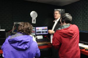 three people inside radio studio