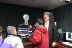 Man talking ibnto mic in radio booth