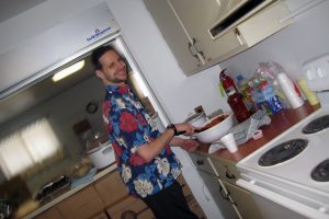 man in kitchen stirring bowl in kitchen