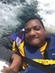 close up of man with eyes closed on boat