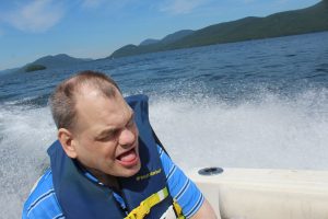 man with mouth open enjoying the lake cruise