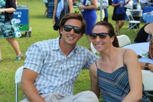 man and woman in sunglasses sitting and smiling