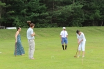 Group of people playing croquet on grass