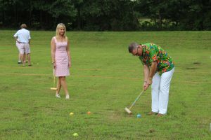 two croquet players in the heat of battle