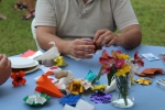 close up on man making paper origami