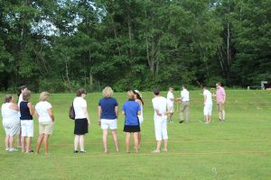 group of people watched foursome finishing up and handshake after croquet round
