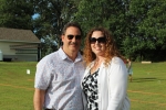 Couple dressed up pose for a picture at AIM Services Croquet on the Green event