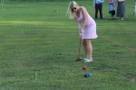 woman in pink dress hitting ball