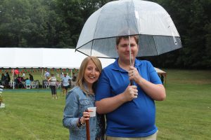 woman and man standing under see through umbrella