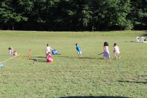 children running around on child version of croquet field