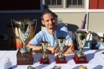 man posing with the four different trophies