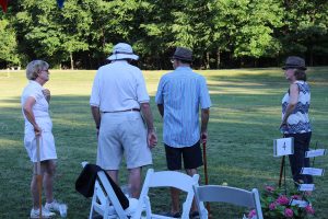 croquet players conversing and talking strategy