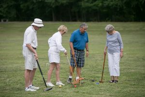 group of four croquet players have the steak surrounded!