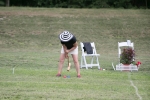 woman in wacky hat strikes ball