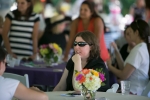 woman in black and sunglasses at table