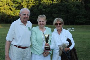 winning team smiles with croquet trophy cup
