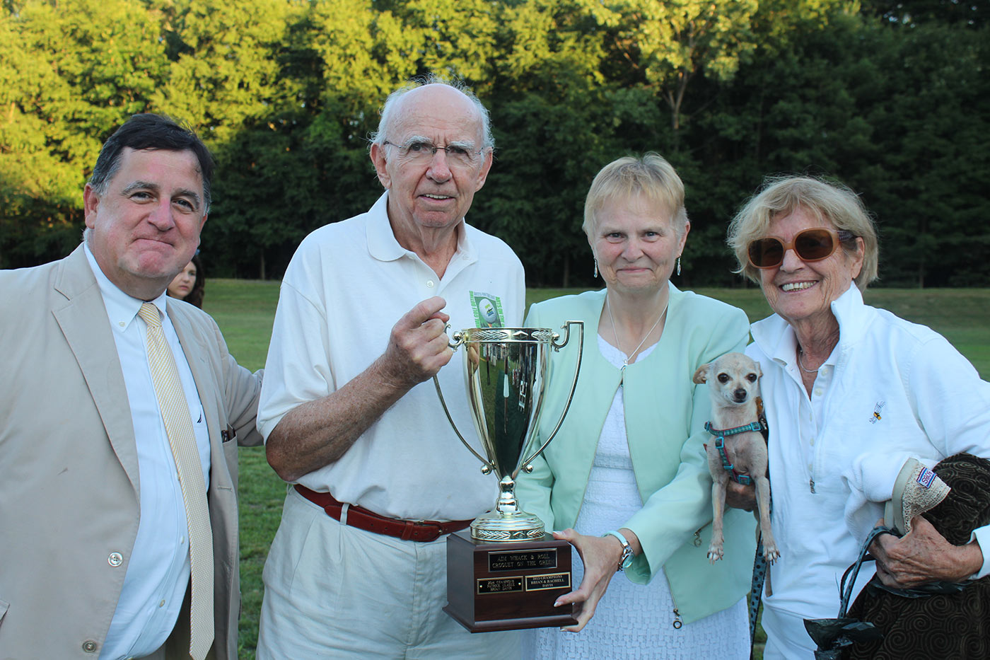 Golfers holding winning trophy