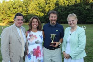 third place winners of croquet tournament show off trophy