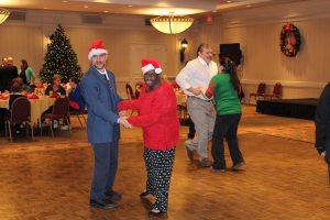 people dancing on the dance floor in Christmas themed clothing