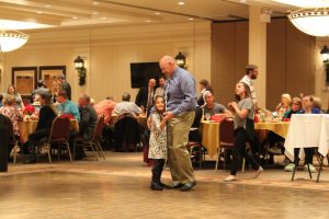 father and daughter dancing on dance floor
