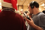 man wearing headphones checks out his gifts