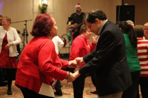 man and woman holding hands shaking a leg on the dance floor
