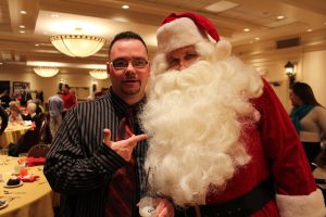 santa and confused man with beer posing for photo
