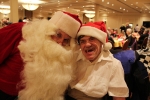 two men in santa suits smiling