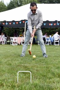 man going with through the legs croquet swing