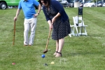 Woman in dark blue dresses Croquet on the Green
