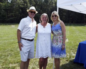 man and two women smiling in fancy clothing at 4th annual croquet on the green