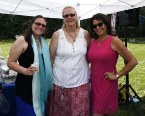 three women standing under dj tent at 4th annual croquet on the green