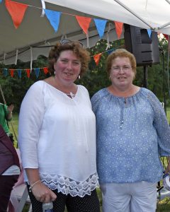 two women smiling under tent at 4th annual croquet on the green