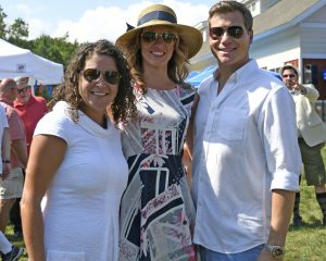 group of three smile on the yard at 4th annual croquet on the green