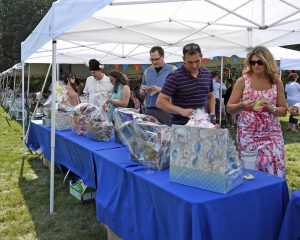 event goers weighing their options on baskets to raffle on