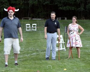 group of three seemingly unhappy with croquet ball results