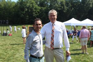 two men smiling with one another at 4th annual croquet on the green